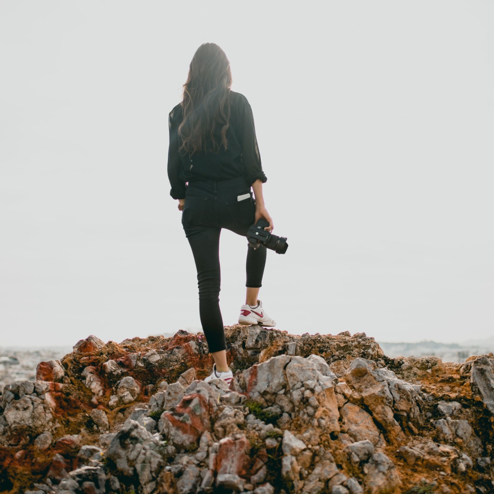 Female photographer on rocks looking at view