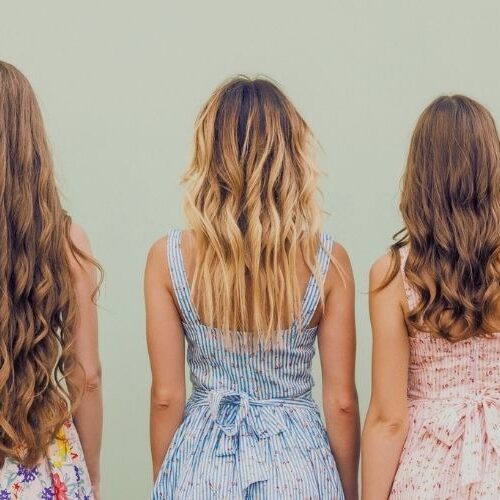 Picture of 3 women turned away from the camera with blank background