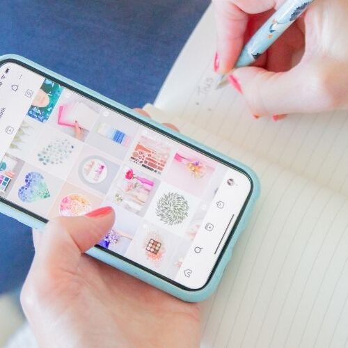 Image of Sarah looking at an Instagram account and taking notes