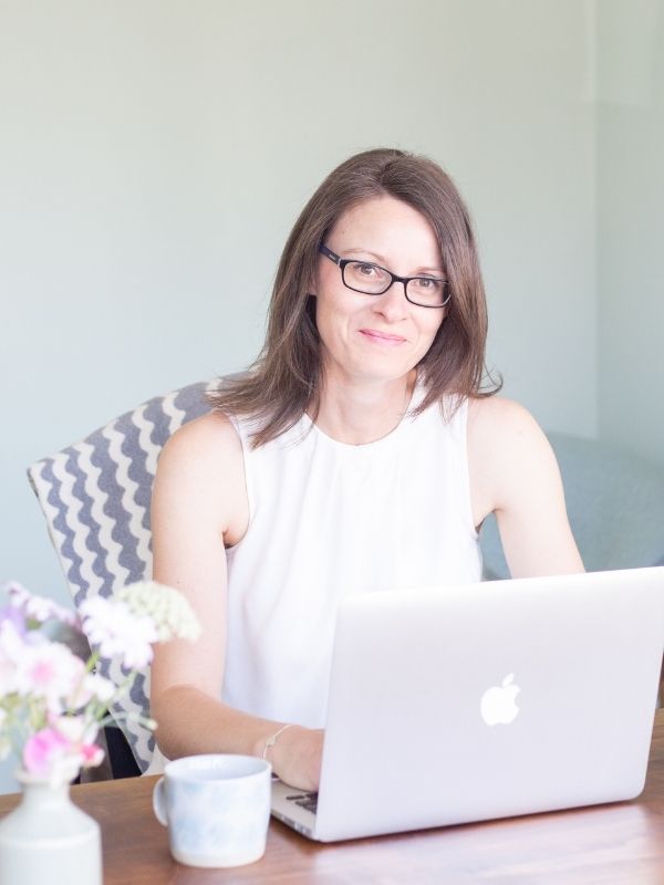 Image of Sarah sitting at her desk