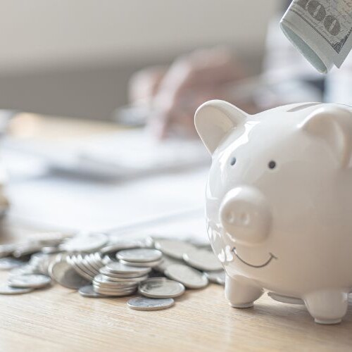 Image of a piggy bank on a desk