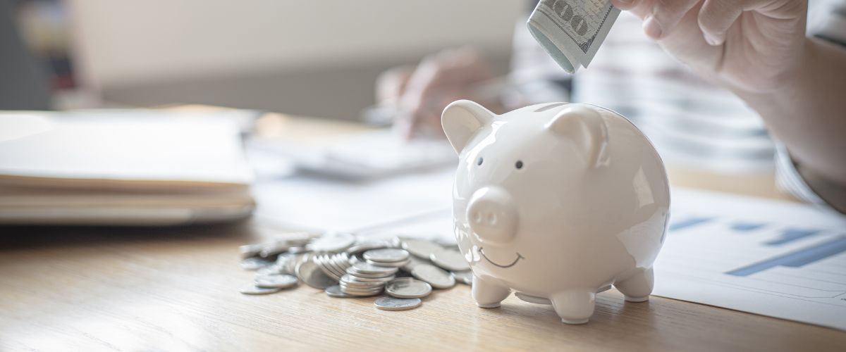 Image of a piggy bank on a desk
