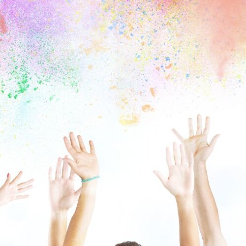 Image of hands in the air and lots of colour to represent winning an Instagram giveaway
