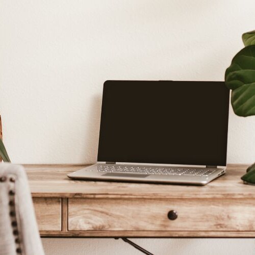 Image of a rustic looking desk with a laptop